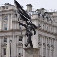 New statue in London, attributed to Banksy, of a suited man, blinded by a flag